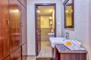 a bathroom with a sink and a toilet at Da Yatra Courtyard Hotel in Pokhara