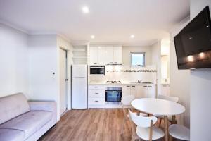 a kitchen with a couch and a table in a room at Myrtleford Holiday Park in Myrtleford