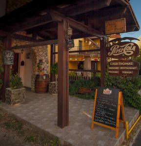 a restaurant with a sign in front of a building at Casa Thomas Bran in Bran