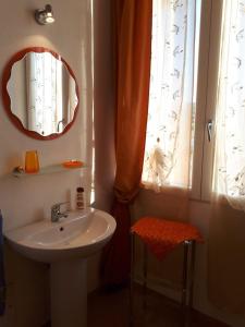カステルサルドにあるAppartamento Lauraのバスルーム(洗面台、鏡、窓付)