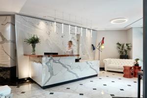 a lobby with a glass wall with a map on it at Antigon Urban Chic Hotel, Thessaloniki in Thessaloniki