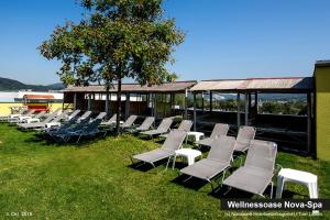 a group of lawn chairs sitting in the grass at NOVAPARK Flugzeughotel Graz in Graz