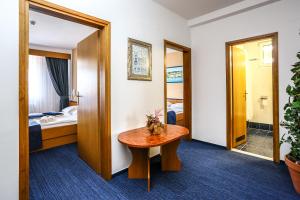 a hotel room with a table and a bed at Hotel Dražica - Hotel Resort Dražica in Krk