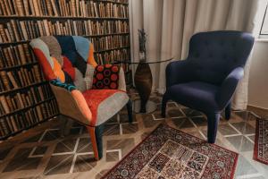 two chairs and a table in a library at Aquapark Design Rooms in Szeged