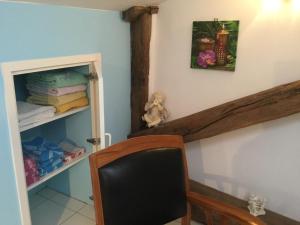 a chair in a room with a closet at Aux Cornettes in Beaune