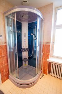a shower with a glass door in a bathroom at 2ndhomes Stunning Top Floor Residence with Sauna and Balcony in Helsinki