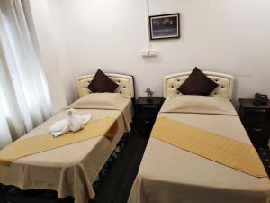 Postel nebo postele na pokoji v ubytování Amax Inn Cebu