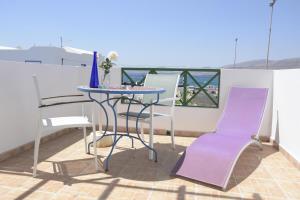 a table and chairs on a balcony with a view at Mar y Sol Terraces Sea Views in Punta Mujeres