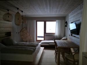 a room with two beds and a couch and a television at Ferienwohungen Wedl in Kleinarl