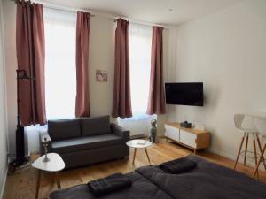 a living room with a bed and a couch at NEW Apartment City Center in Vienna