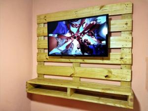 a television in a wooden box on a wall at HOTEL KISS - TABOÃO DA SERRA in Taboão da Serra +24 photos