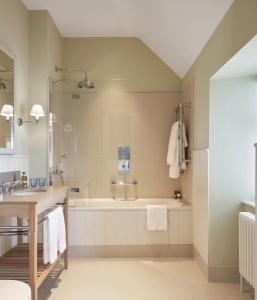 a bathroom with a tub and a sink at Machrie Hotel & Golf Links in Port Ellen