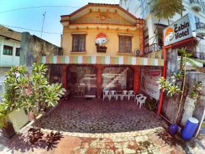 a store front with chairs in front of a building at Cabin Hotel Bhayangkara in Yogyakarta