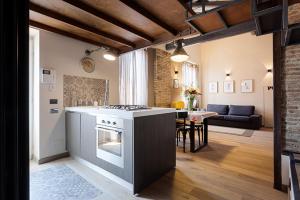 a kitchen with a stove and a living room at Loft Navona in Rome