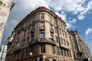 um edifício alto com uma varanda em cima em Old City Hostel em Lviv
