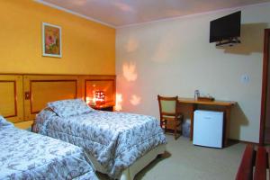 Кровать или кровати в номере Pousada Vilage Inn Capivari Campos do Jordão