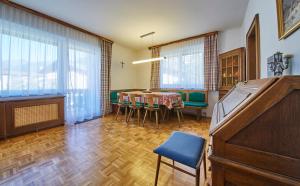 a room with a table and chairs and a piano at Appartement Retreat in Saalbach Hinterglemm