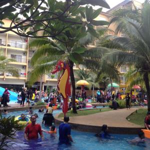 a group of people in a pool at a resort at ZamLan Gold Coast Morib Intl Resort - 3 Rooms Apartment in Banting +29 photos
