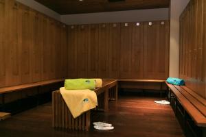 
a room with a wooden bench and a wooden table at Kubija Hotel and NatureSpa in Võru
