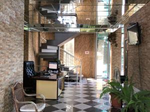 a lobby with a desk and stairs in a building at Hotels Piza in Tbilisi City