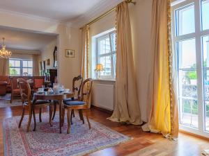 a dining room with a table and chairs at VacationClub - Trzy Korony Piastów Apartament 37 in Świnoujście