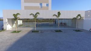 a building with palm trees in front of it at Hotel Oásis de Patos in Patos