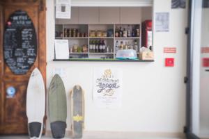 a display of surfboards on a wall in a room at WOT Ericeira Surf Hostel in Ericeira