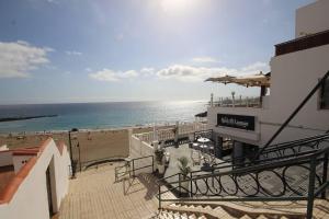 a view of the beach from the balcony of a building at Luxury Apartment Cristianos Beachfront in Los Cristianos