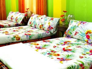 a living room with two couches with flowers on them at Prosperity Inn in Vigan