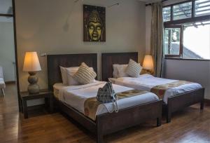 Postel nebo postele na pokoji v ubytování Beach Front Villa