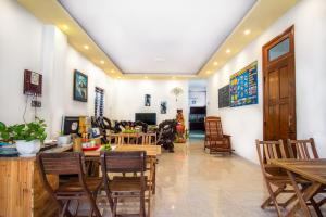 a living room with wooden tables and chairs at Golden Bee Homestay in Hoi An