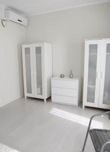 a white room with three cabinets and a dresser at Barcelona Family Beach in Barcelona