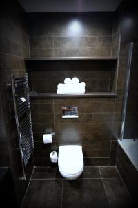 a bathroom with a toilet and a sink at Best Western Plus Aston Hall Hotel in Aston