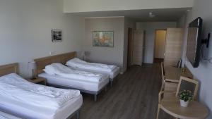 En eller flere senge i et værelse på Hótel Borgarnes