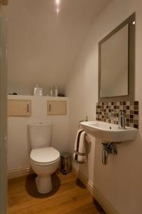 a bathroom with a toilet and a sink at Squeak Cottage in Harrogate