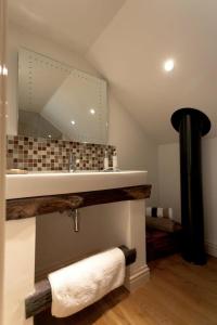 a bathroom with a sink and a mirror at Squeak Cottage in Harrogate