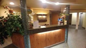 a bar in a lobby with a palm tree at Palace Inn & Suites in Lincoln City