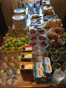 a table topped with lots of different types of food at Casa Rural Sierra de Tormantos in Guijo de Santa Bárbara