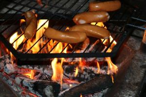 a group of sausages cooking on a grill at Päärakennus in Karijoki