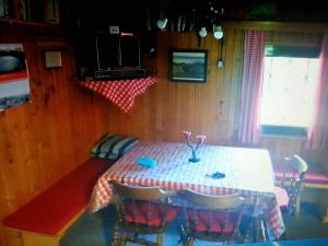 a dining room with a table and some chairs at Chalet Kanja Velika Planina in Stahovica
