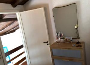a mirror on a wall next to a door at Casa delle Galee in Scilla +65 photos