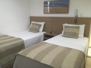 Postel nebo postele na pokoji v ubytování Hotel Dom Passos + 26 fotografií
