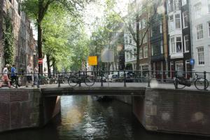 a bridge over a canal with bikes on it at Orange City Studio Amsterdam in Amsterdam