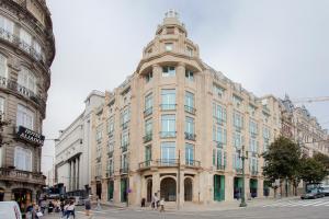 a large building with a tower on top of it at Liiiving in Porto | Aliados Luxury Apartments in Porto