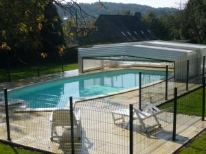 a swimming pool with a fence around it at Gite Ker Maria Gite Ker Louis Piscine in Saint-Gravé