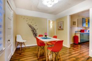 a dining room with a table and red chairs at Casa San Diego in San Diego