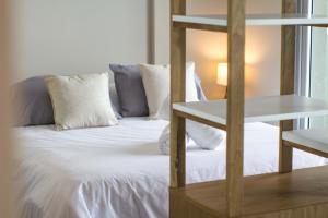 a bedroom with a bed with white sheets and pillows at High End Studio in Central Recoleta -12J- in Buenos Aires