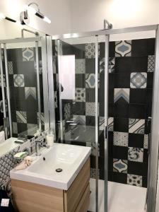 a bathroom with a sink and a shower at AzzurRomare Flat apartment in Lido di Ostia +45 photos