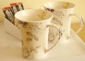two cups sitting on a shelf with butterflies on them at Gordon House in Wimborne Minster +47 photos