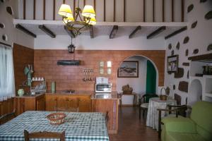 a kitchen with a table and a dining room at Casa Servando in Tejeda